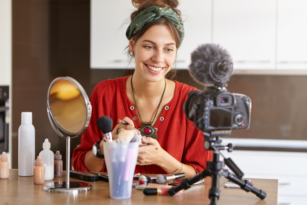 female vlogger filming makeup video