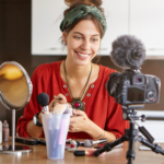 female vlogger filming makeup video