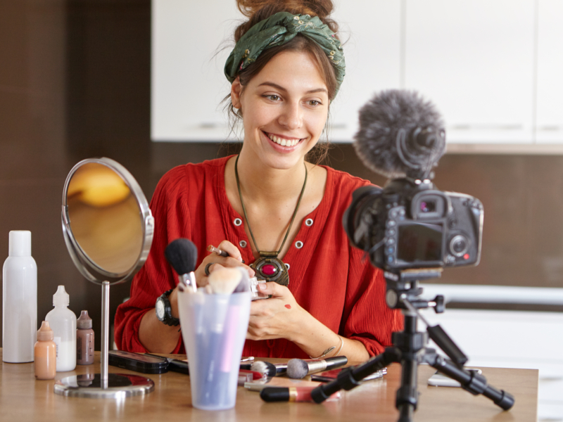 female vlogger filming makeup video